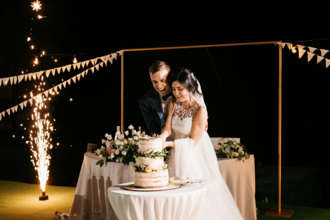 newlyweds happily cut and taste the wedding cake newlyweds happily cut and taste the wedding cake