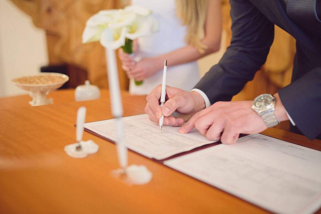 Bride and Groom Sign Wedding Document Together