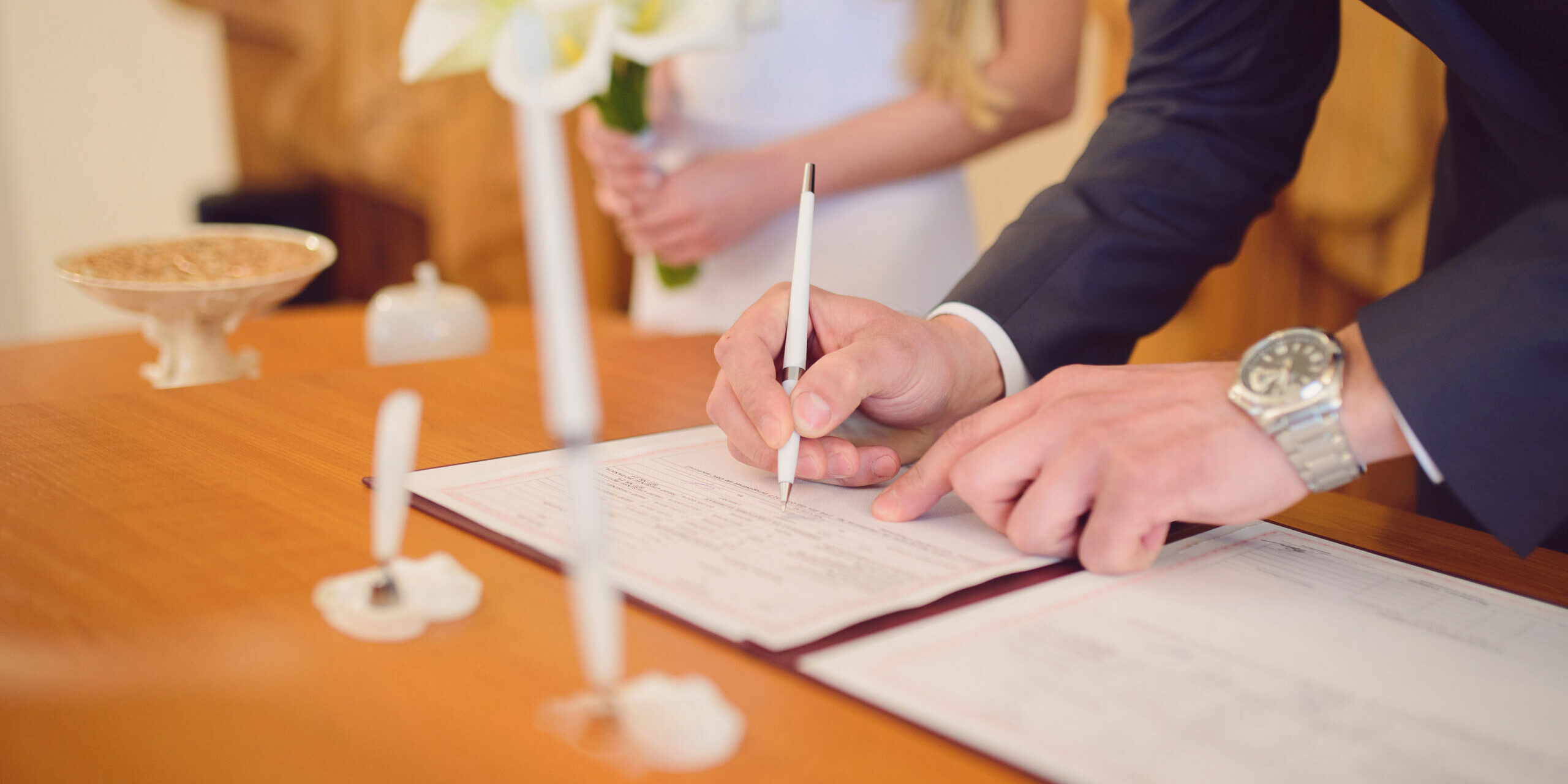 Bride and Groom Sign Wedding Document Together